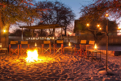 Around the camp fire at night, Deception Valley Lodge, Botswana