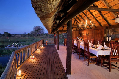 Dining area and verandah with view at Gunn's Camp, Okavango Delta