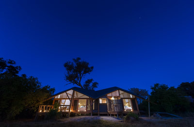 Luxury tented accommodation at night, Splash Camp