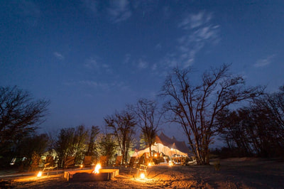 Campfire and main area at night, Mankwe Bush Lodge