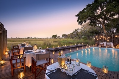 Nxabega Okavango Tented Camp dining at the swimming pool