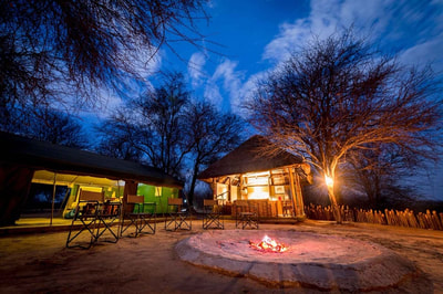 Fire pit and main area at night, Tusker's Bush Camp, Botswana